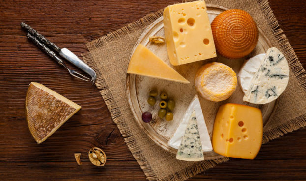 Mix cheese on wooden board.