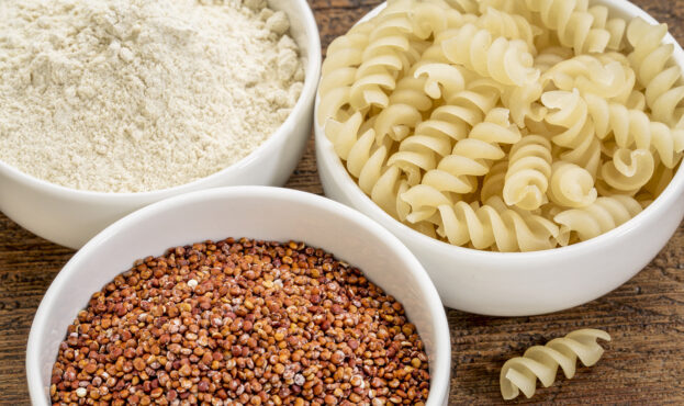 gluten free quinoa grain, flour and pasta on small ceramic bowls