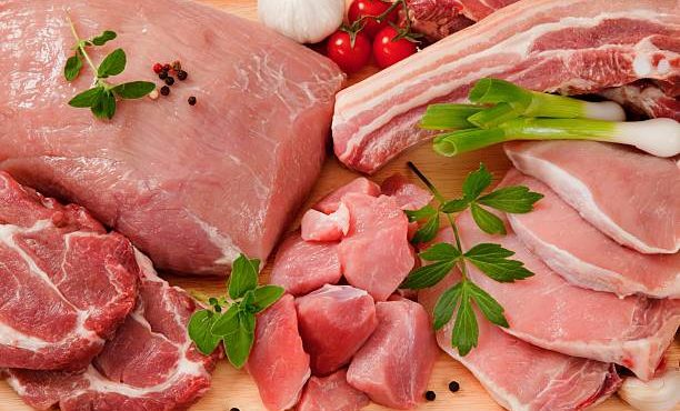 Various cuts of pork meat on a chopping board